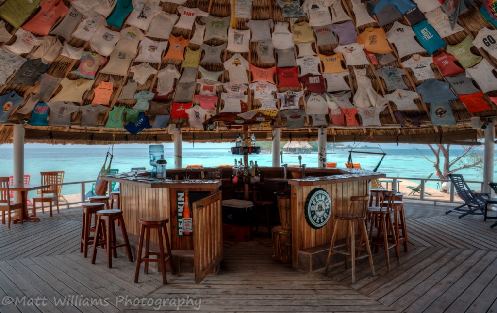 Thatch roof bar at all inclusive Coco Plum Island Resort in Belize