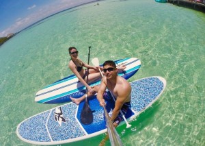 couple paddle boarding in belize