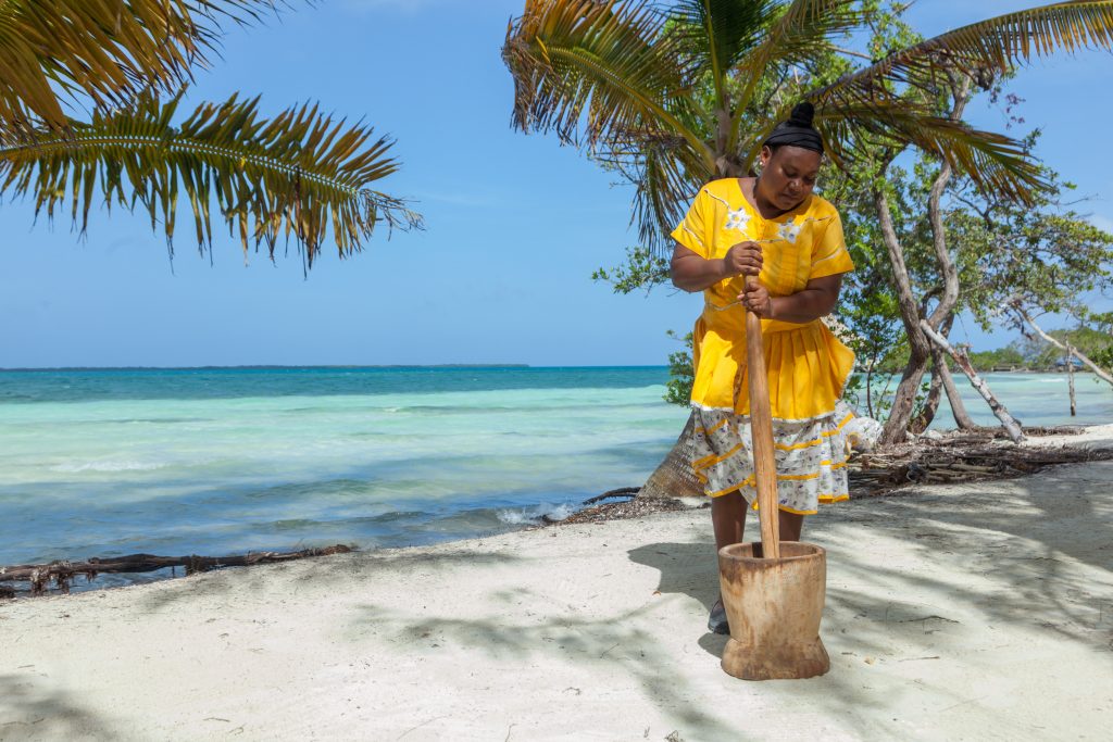 Ms. Jude cooking a traditional Garifuna meal, Hudut at Coco Plum Island Resort 