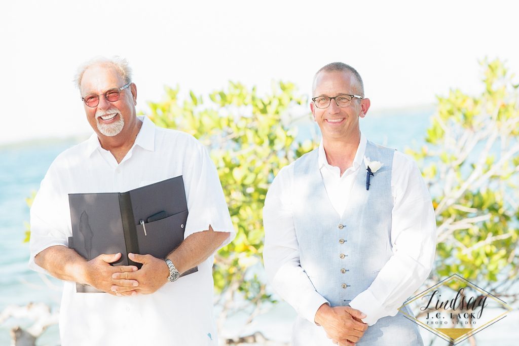 Officiant and groom during a Belize destination wedding at Coco Plum Island Resort