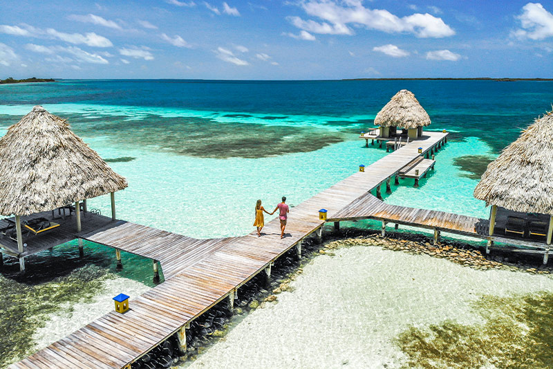 A couple in Belize enjoying a romantic vacation afforded by taking advantage of one of our private island honeymoon packages.