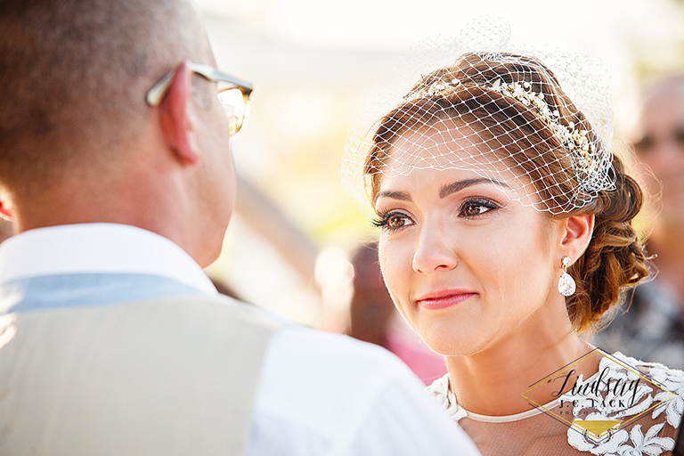 Bride looks lovingly at groom during their wedding ceremony