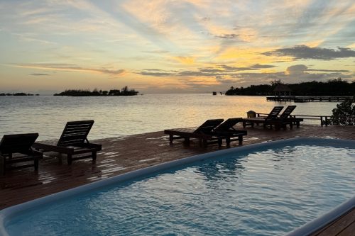 Tiki bar pool at sunset.